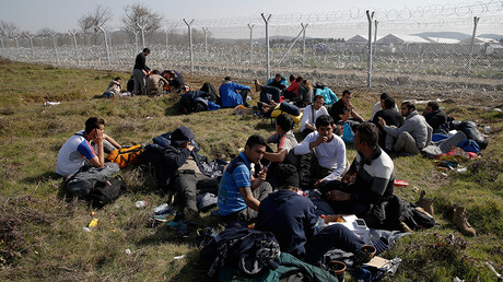 Migrants from Afghanistan who were sent back from the Serbian border rest next to a border fence at the Macedonian-Greek border in Gevgelija, Macedonia February 23, 2016 © Marko Djurica