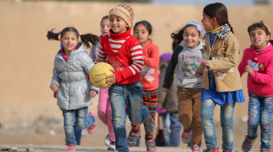 School children play with a ball in a playground in Ras al-Ain city, Syria. © Rodi Said