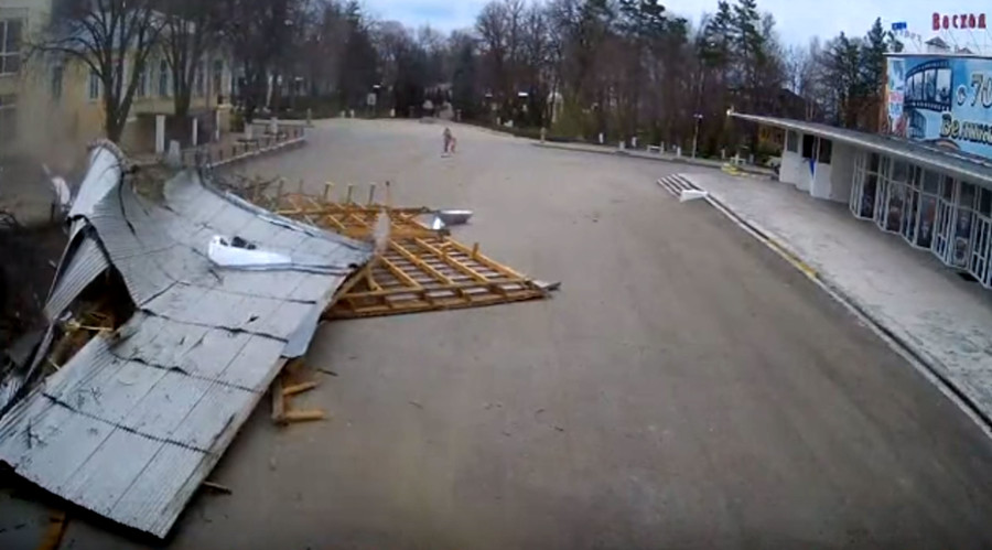 Miracle escape: Roof blown off building lands dangerously close to woman & child (VIDEO)