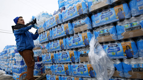 Volunteers distribute bottled water to help combat the effects of the crisis when the city's drinking water became contaminated with dangerously high levels of lead in Flint, Michigan, March 5, 2016. © Jim Young 