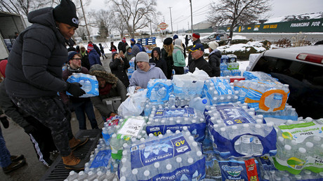 Volunteers distribute bottled water to help combat the effects of the crisis when the city's drinking water became contaminated with dangerously high levels of lead in Flint, Michigan, March 5, 2016. © Jim Young 