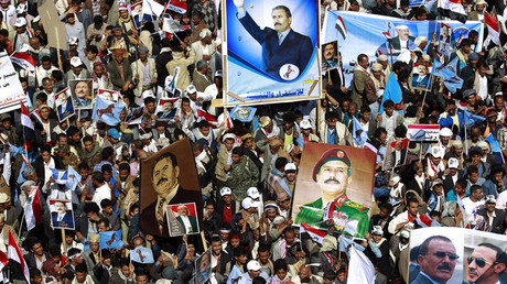 Yemenis hold placards bearing portraits of former president Ali Abdullah Saleh during a protest against the Saudi-led coalition, on March 26, 2016, in the Yemeni capital Sanaa. © Mohammed Huwais