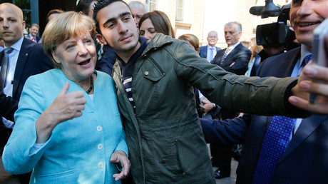 A migrant takes a selfie with German Chancellor Angela Merkel © Fabrizio Bensch 