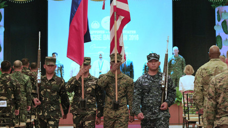 Soldiers carry a Philippine and U.S. flags during the exit of colours, as part of the opening ceremony of the 2016 Balikatan military exercises at the Armed Forces of the Philippines (AFP) headquarters in Camp Aguinaldo, Quezon city, metro Manila April 4, 2016. © Romeo Ranoco