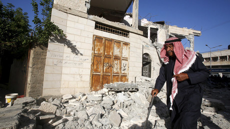 A man walks past the damaged house of Palestinian assailant Ahmad Zakarneh after it was partially demolished by Israeli forces in the West Bank town of Qabatya near Jenin April 4, 2016. © Abed Omar Qusini