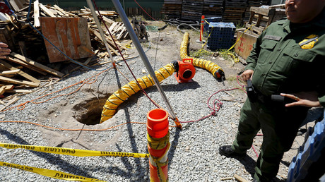 U.S. Border Patrol officer Cesar J. Sotelo stands guard over a hole in the ground after the discovery of a cross-border tunnel from Tijuana, Mexico to Otay Mesa, California April 20, 2016. © Mike Blake