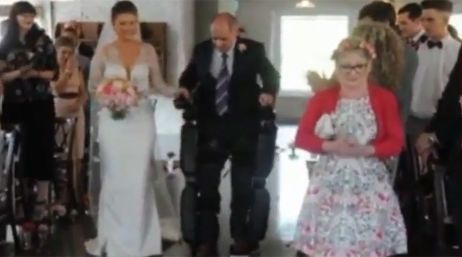 Paralyzed dad dons robot suit to walk daughter down the aisle (VIDEO)