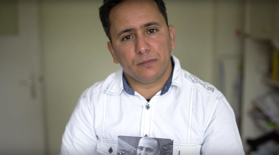 Yahdih Ould Slahi holds up a photo of his brother Mohamedou in a May 2016 video by American Civil Liberties Union © acluvideos