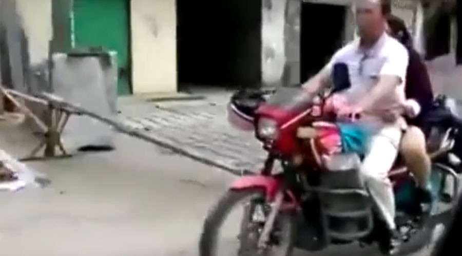 Blind luck: Sightless Chinese man drives motorbike as wife gives directions (VIDEO)