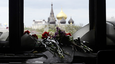 Flowers on a broken window in memory of the people killed by fire in the Trade Unions House on Odessa's Kulikovo Pole square. © Anton Kruglov