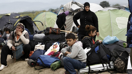 A refugee family sit in front of their tent waiting to be transferred to hospitality centres, during a police operation at a refugee camp at the border between Greece and Macedonia, near the village of Idomeni, Greece, 24 May 2016 © Yannis Kolesidis