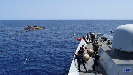 Migrants are rescued from a capsized boat during a rescue operation by Italian navy ships 