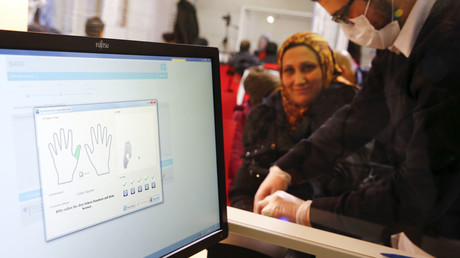 A Syrian woman gets her fingerprints taken at a registration centre in Herford, western Germany © Wolfgang Rattay