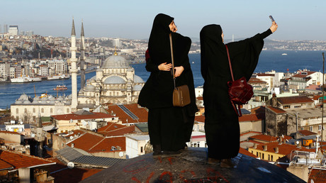 Women take selfie photographs with Hagia Sophia in the background in Istanbul, Turkey © Murad Sezer 