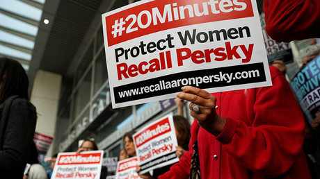 Activists hold signs calling for the removal of Judge Aaron Persky from the bench after his controversial sentencing in the Stanford rape case, in San Francisco, California, U.S. June 10, 2016. © Stephen Lam