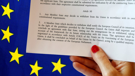 Article 50 of the EU's Lisbon Treaty that deals with the mechanism for departure is pictured near an EU flag following Britain's referendum results to leave the European Union, in this photo illustration taken in Brussels, Belgium, June 24, 2016. © Francois Lenoir