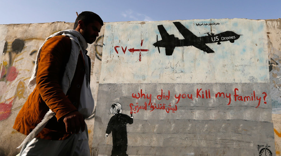 A man walks past a graffiti, denouncing strikes by U.S. drones in Yemen, painted on a wall in Sanaa November 13, 2014. © Khaled Abdullah 