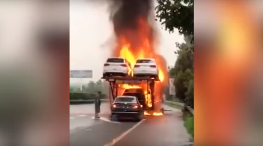 Driver reverses new car off of blazing transporter (VIDEO)