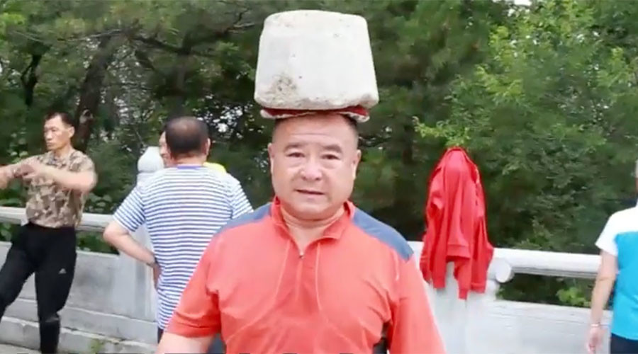 Ready to rock: Chinese man sheds 66lbs by carrying boulder on head (VIDEO)