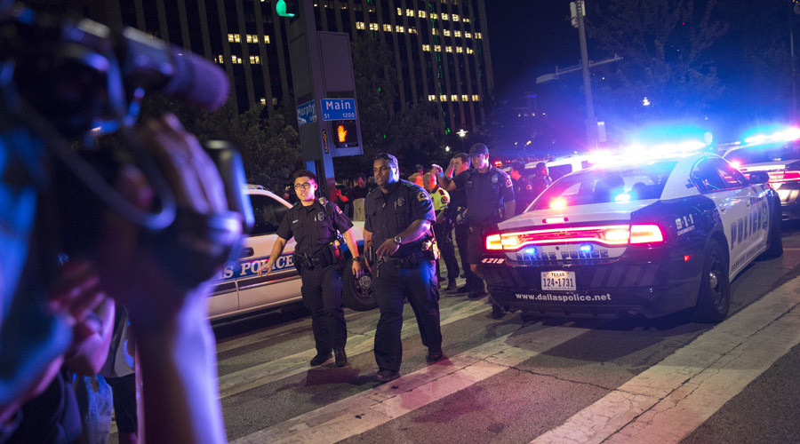 Bystanders stand near pollice baracades following the sniper shooting in Dallas on July 7, 2016. © Laura Buckman