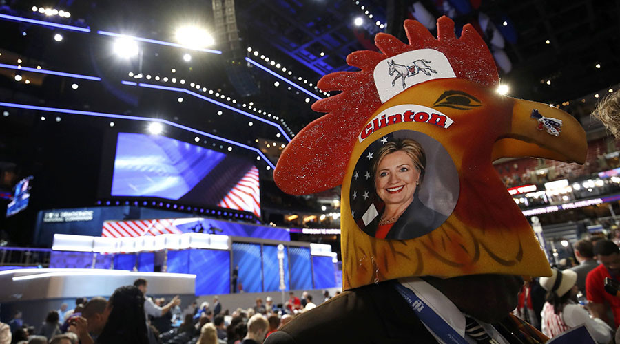 A delegate wearing rooster headgear with a picture of Democratic U.S. presidential candidate Hillary Clinton on the side walks across the floor of the convention during the second night at the Democratic National Convention in Philadelphia, Pennsylvania, U.S., July 26, 2016. © Jim Young