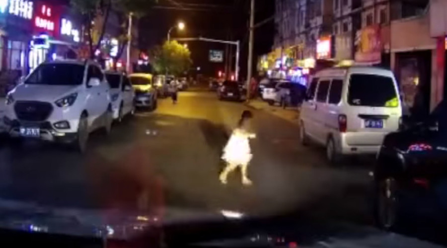 Young girl hit by car after running across road, walks away uninjured (SHOCKING VIDEO)