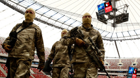 Soldiers walk after a demonstration of their skills during a military police exercise, ahead of the NATO summit in July in Warsaw, at the PGE National Stadium in Warsaw, Poland © Kacper Pempel 