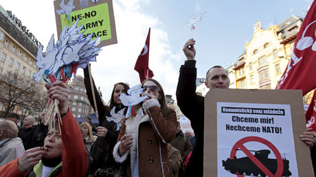 Supporters of the Communist Party hold signs and whistles during a demonstration against the U.S. Army's 