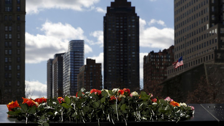 Flowers are seen on the reflecting pool of the 9/11 Memorial. © Shannon Stapleton