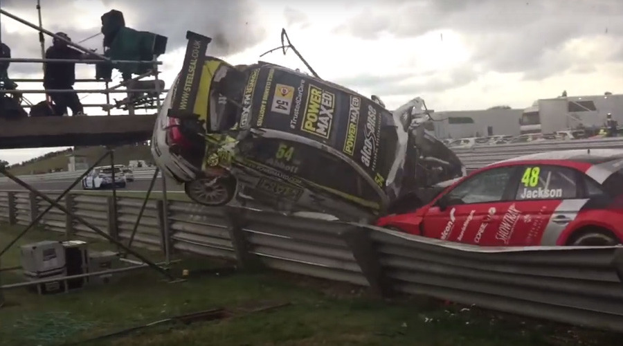 Sportscar plunges into TV camera tower at race (VIDEO)