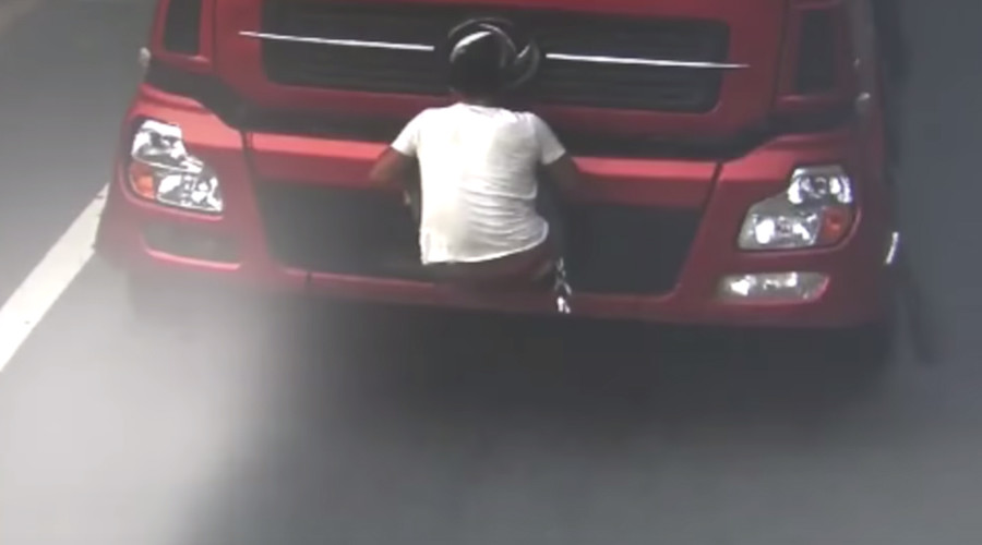 License to thrill: Chinese truck driver uses body to block registration plate