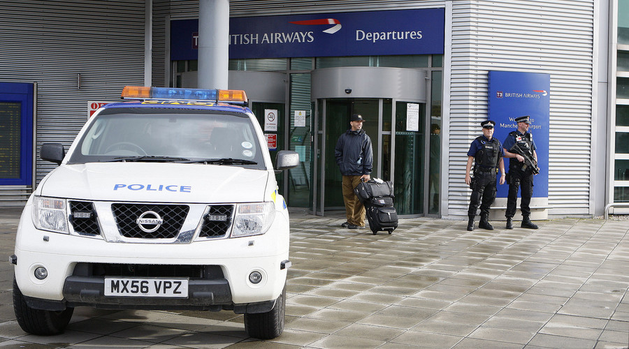 Armed police officers stand guard at the entrance at Manchester airport in Manchester, northern England. File photo. © Phil Noble