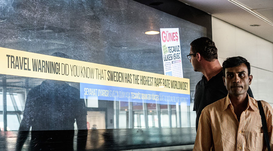 A passenger looks around to read a billboard that reads, 'Travel warning - Do you know that Sweden has the highest rape rate worldwide?' at the departures area of the Istanbul Ataturk International airport on August 19, 2016. © Ozan Kose 