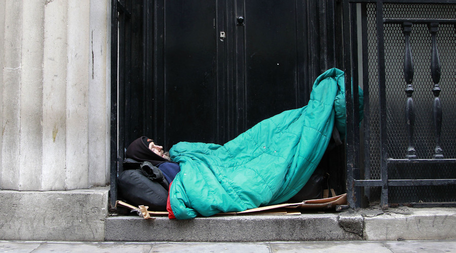 A homeless man sleeps in a doorway in central London. © Stefan Wermuth 