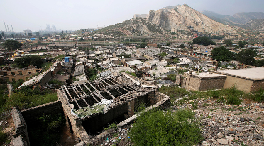 Abandoned houses are seen in an area where land is sinking near a coal mine in Kouquan township of Datong, China's Shanxi province, August 1, 2016. © Jason Lee