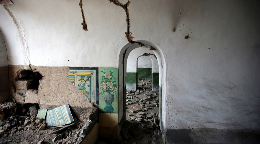 Damaged walls are seen inside an abandoned cave house in an area where land is sinking next to a coal mine in the deserted Liuguanzhuang village of Datong, China's Shanxi province, August 1, 2016. © Jason Lee