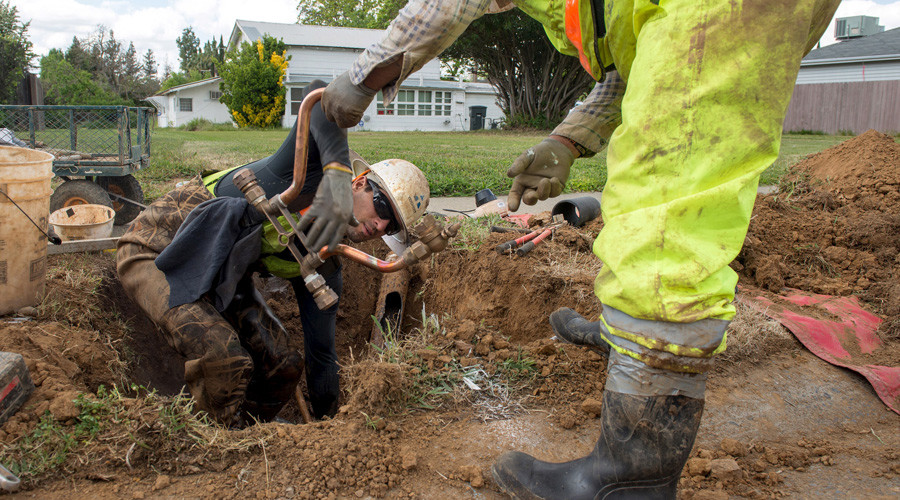 Head first: Photo of utility worker submerged up to waist goes viral