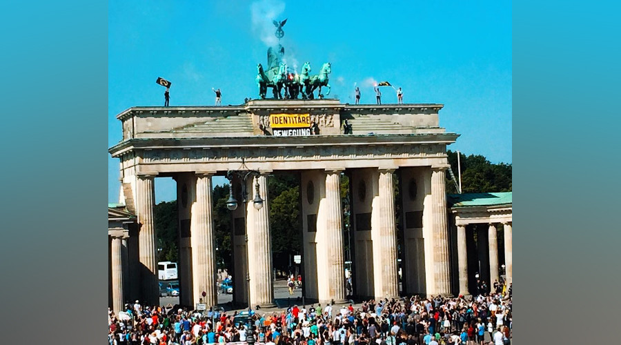 ‘Fortress Europe’: Anti-refugee activists climb Brandenburg Gate to oppose ‘rampant’ immigration