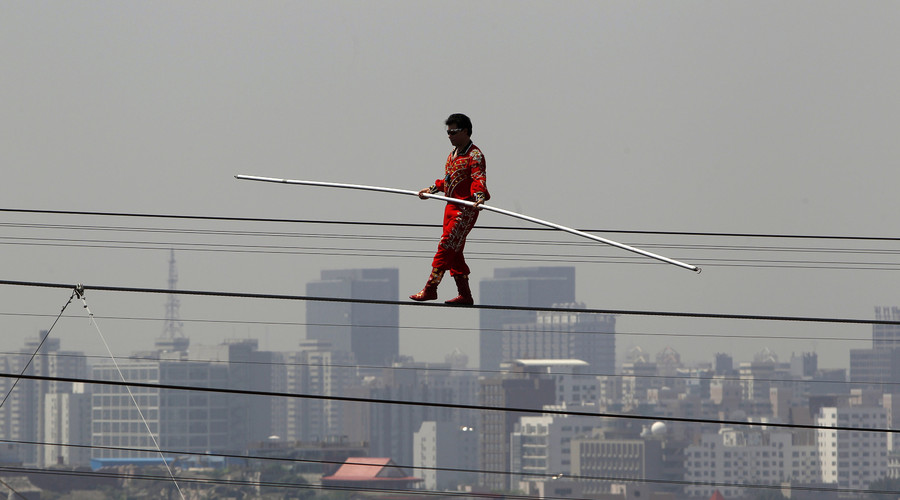 Adili Wuxor, known as "Prince of the Tightrope", walks the tightrope above the "Bird's Nest" Olympic stadium in Beijing. File photo. © Bobby Yip