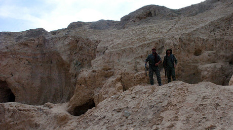 A picture taken on August 3, 2016 shows two fighters from the Syrian Democratic Forces, the Kurdish-Arab alliance backed by the US fighting the Islamic State (IS) group, standing at the Tal Ajaja archeological site in Syria's northeastern Hassakeh province. © Ayham al-Mohammad