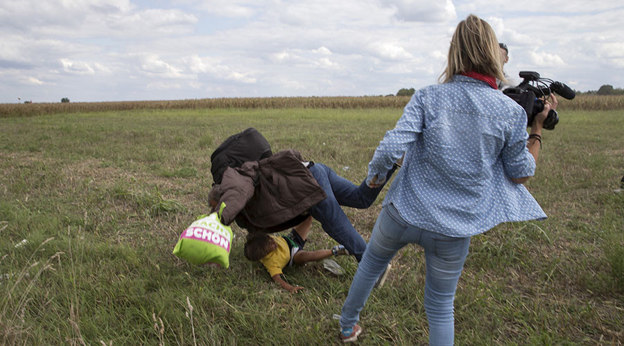 Camerawoman who kicked fleeing refugees charged in Hungary