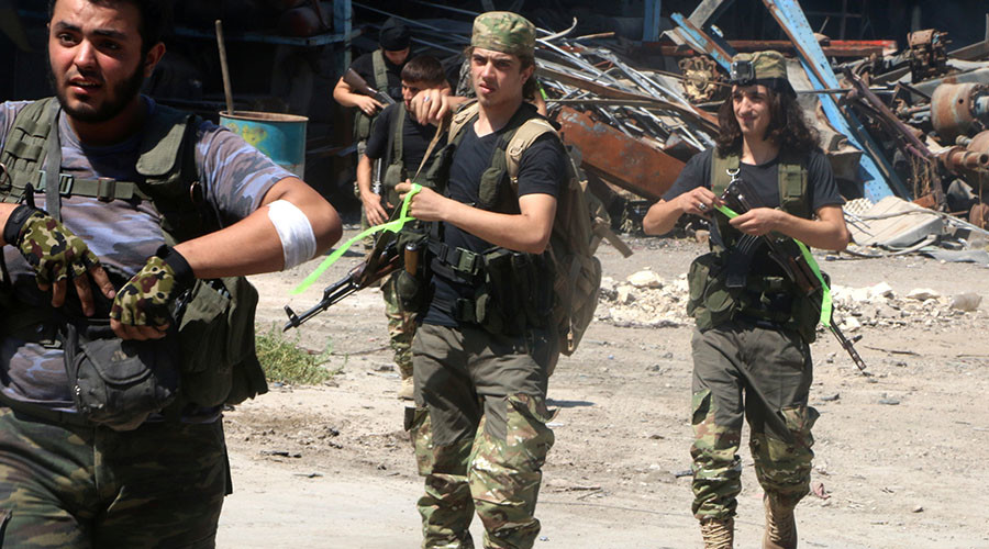 Free Syrian Army fighters walk with their weapons in Ramousah area southwest of Aleppo, Syria. © Abdalrhman Ismail