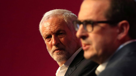 Britain's Labour leader Jeremy Corbyn (L) listens to Owen Smith during tonight's debate at a Labour Leadership Campaign event in Glasgow, Scotland, August 25, 2016. © Russell Cheyne