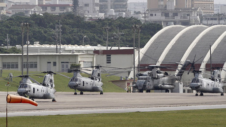 Four Sea Knight transport helicopters and a Super Stallion helicopter are parked at Marine Corps Air Station Futenma in Ginowan on Okinawa. © Toru Hanai