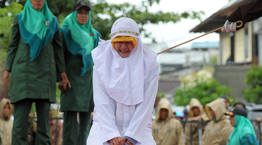 Indonesian woman flogged for standing too close to boyfriend (PHOTOS)