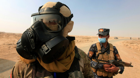 Iraqi forces wear protective masks after winds brought fumes from a nearby sulfur plant set alight by Islamic State militants, at south of Mosul in Qayyara, Iraq, October 22, 2016. © Alaa Al-Marjani