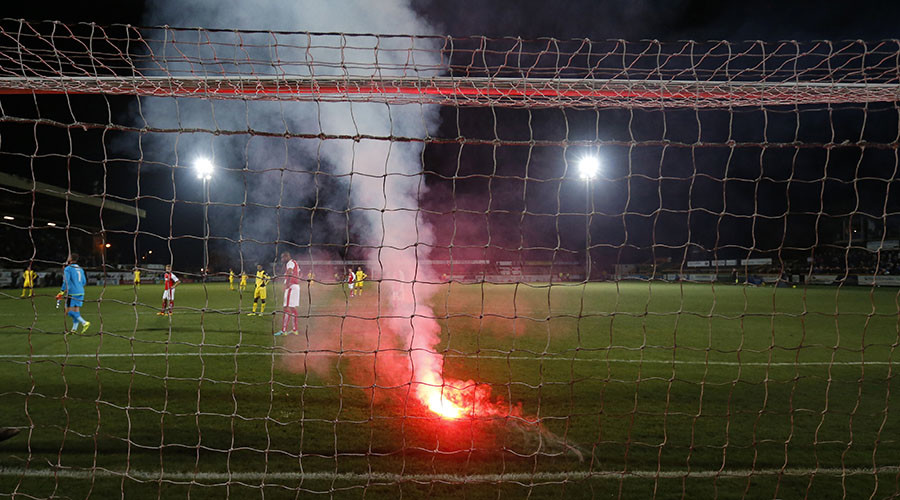 Flares thrown by English football fans miss players by inches during FA Cup tie (VIDEO)