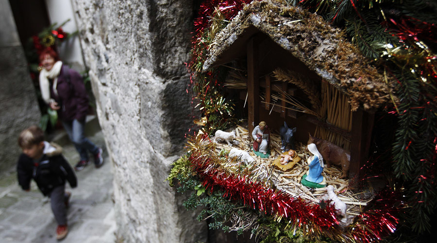 People pass by a Christ's nativity scene displayed in a street of Luceram, southeastern France, on December 21, 2015. © Jean Christophe Magnenet / AFP
