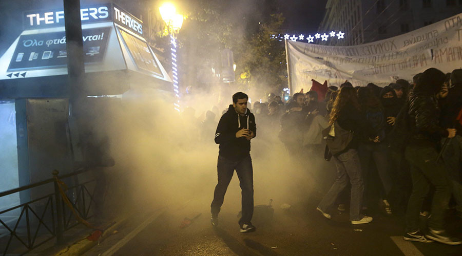 Protesters run away from teargas as they clash with riot police during a demonstration against the visit of U.S President Barack Obama, in Athens, Greece, November 15, 2016. © Alkis Konstantinidis