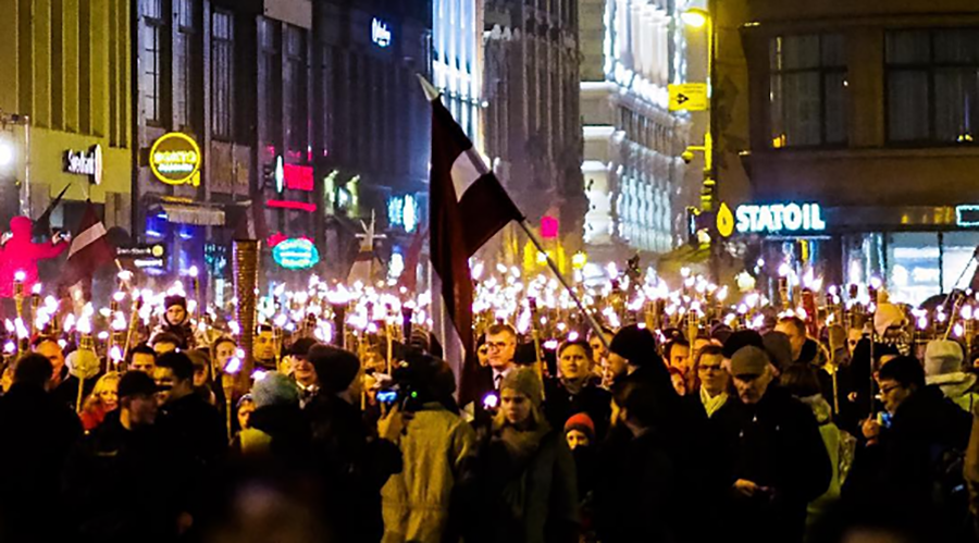‘We are Latvians!’ 1,000s join far-right torchlight procession in Riga